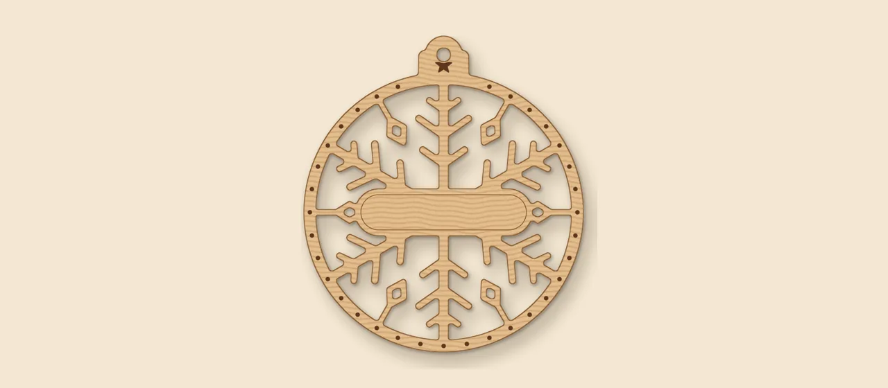 Snowflake filigree ornament laser file with a name band, shown as a wood render